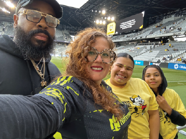 teacher and students at soccer stadium